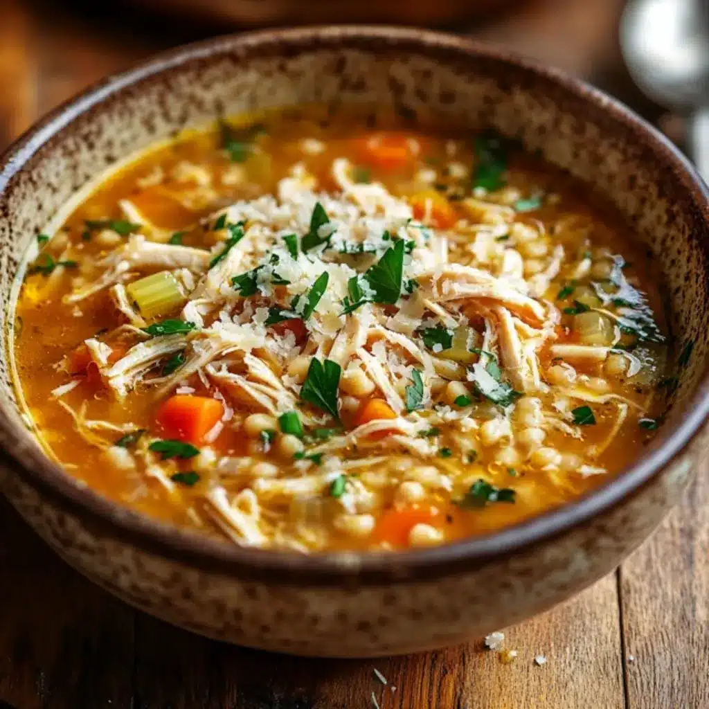 Top 18 Soup Recipes We Love to Make at FreshRecips 17 Bowl of chicken couscous soup with shredded chicken, carrots, celery, and fresh parsley, topped with grated cheese.
